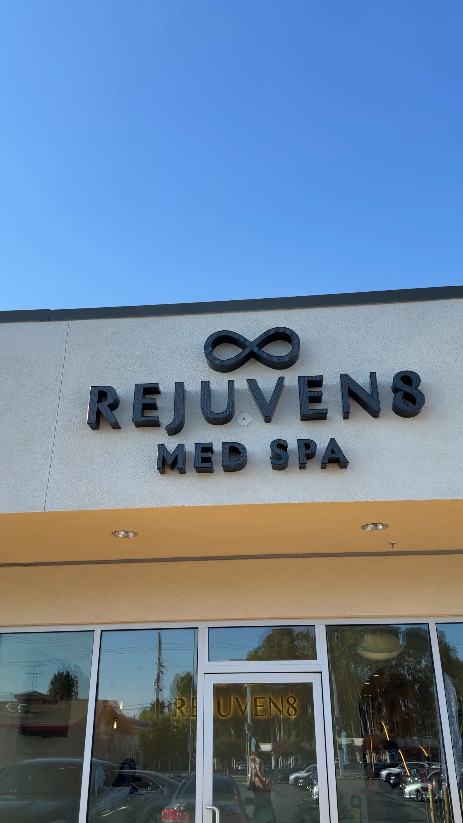 The Rejuven8 Med Spa sign above the studio's glass storefront